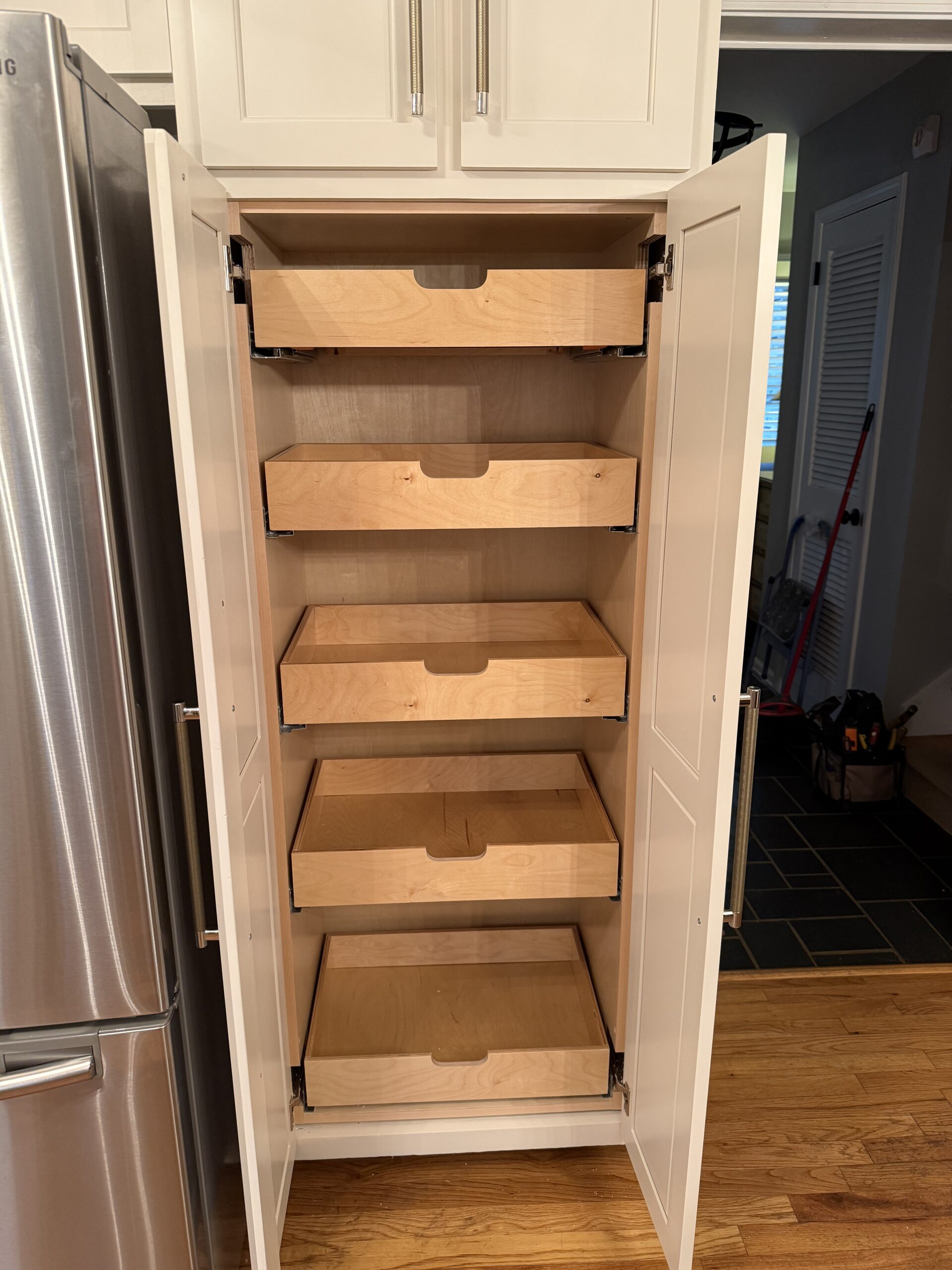Pull-out pantry drawers installed by Pro Finish Craftsmen for better kitchen storage.